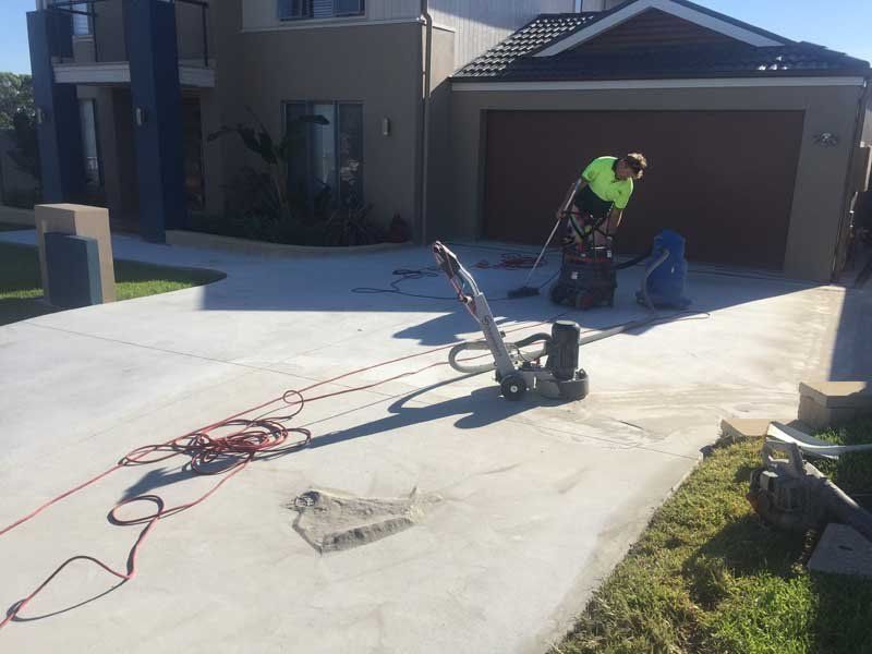 worker resurfacing concrete