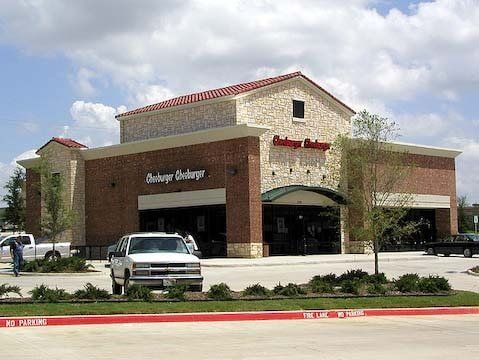Hamburger Stanburger restaurant exterior with brick and stone facade, a white truck parked in front.