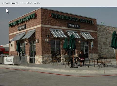 Starbucks coffee shop in Grand Prairie, TX, with outdoor seating and a drive-thru.