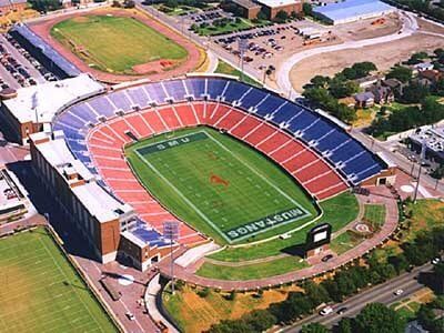 Aerial view of Gerald J. Ford Stadium, home of the SMU Mustangs, with red and blue seating, green field, and running track.