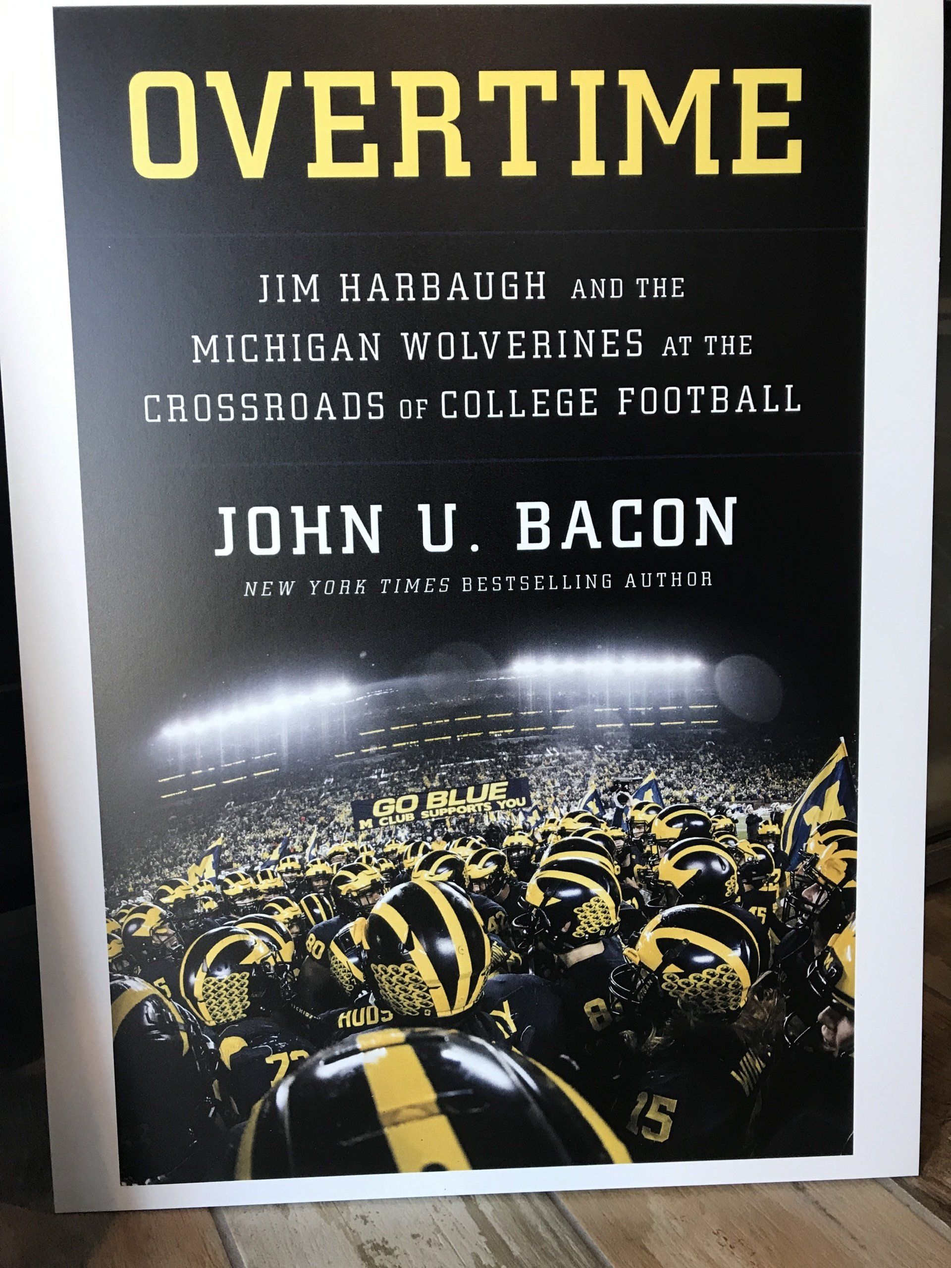 Book cover titled “OVERTIME” with a football stadium crowd at night under bright lights