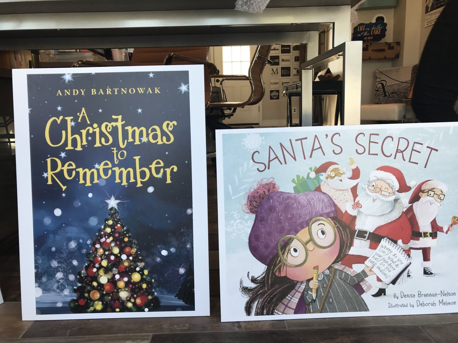 Two children’s Christmas book covers on a shelf, including “A Christmas Remembered” and “Santa’s Secret.”