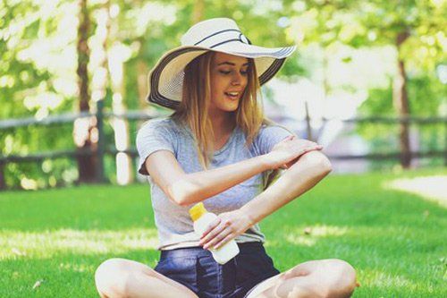 Young Woman Applying Sunscreen