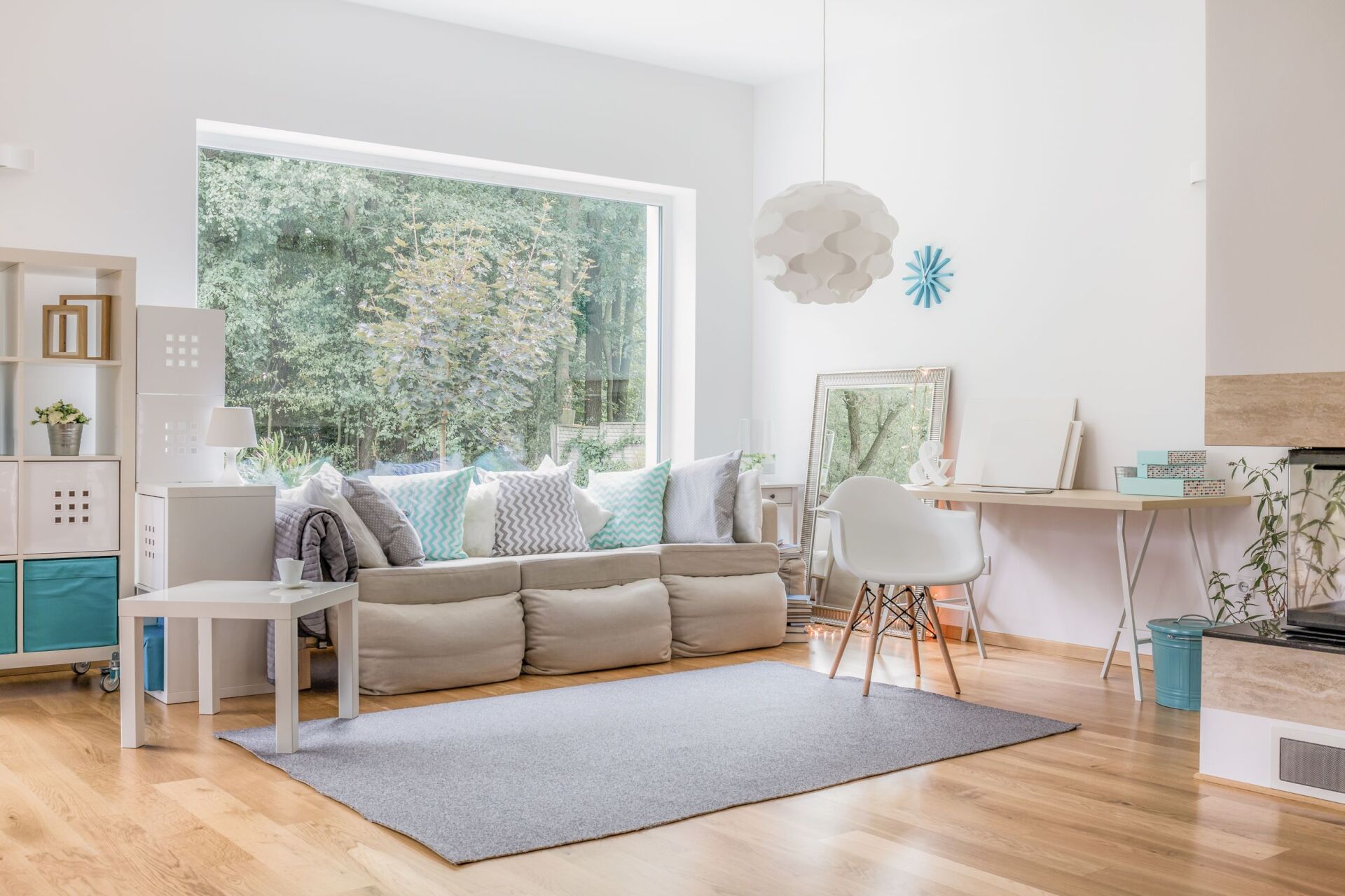 A living room with a large window and a couch.