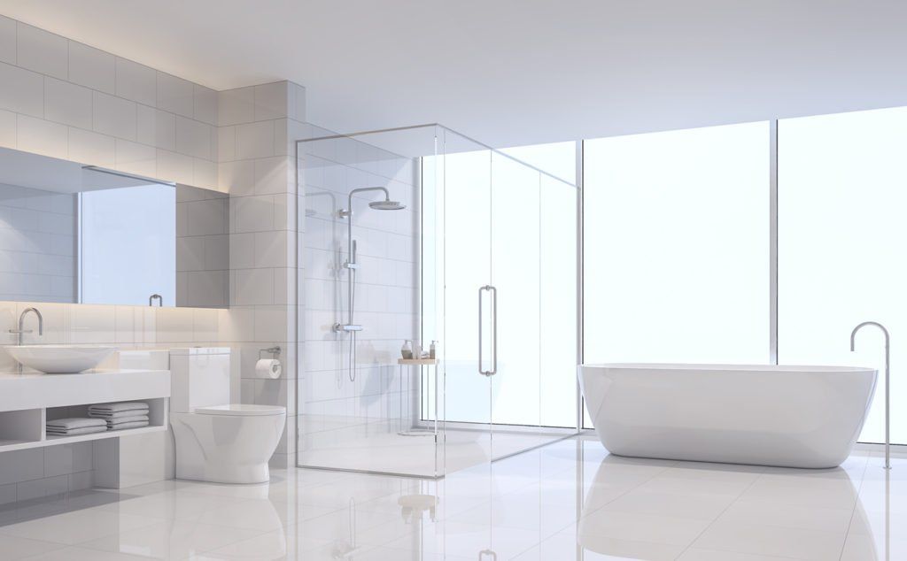 A bathroom with a bathtub , toilet , sink and shower.