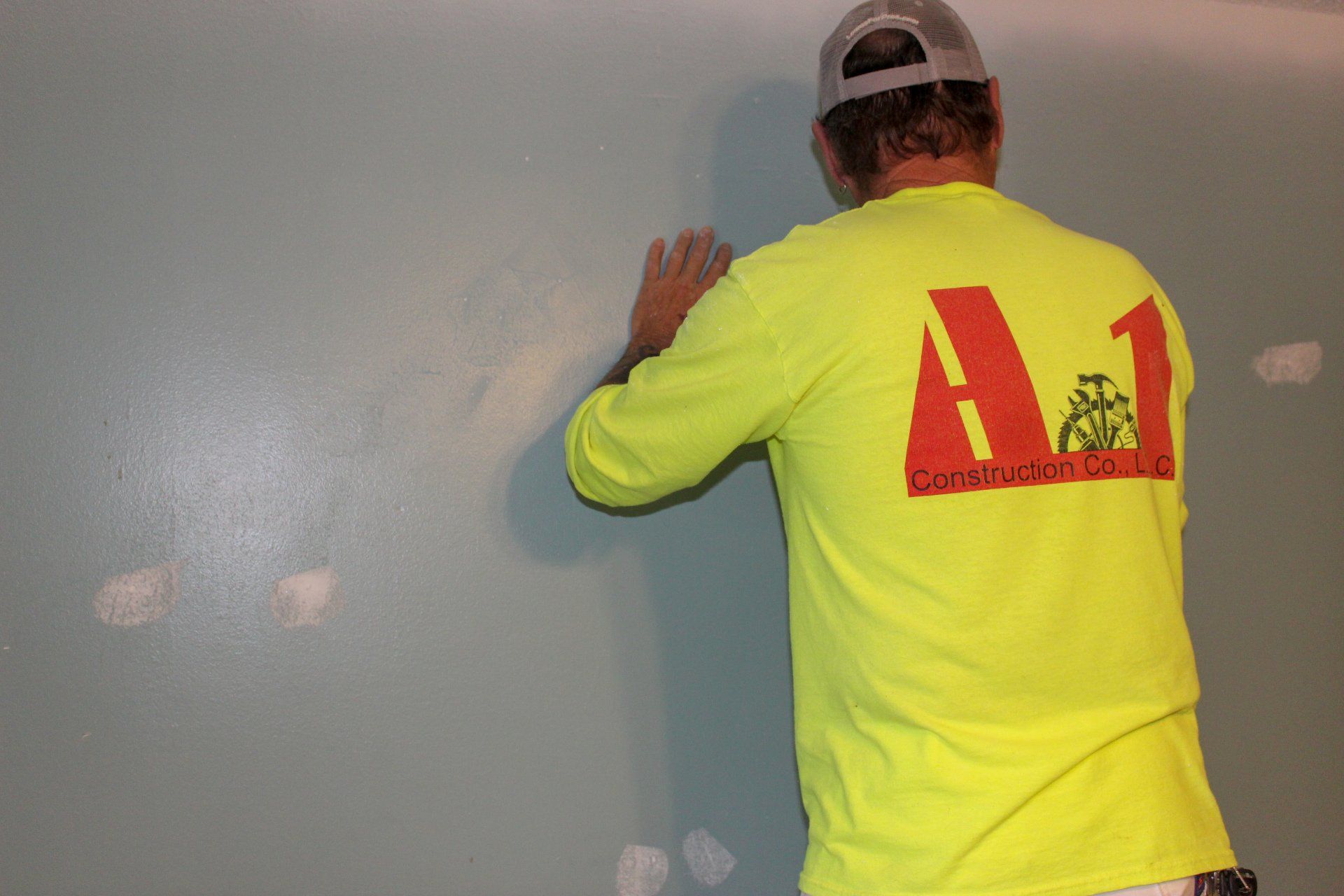man patching and sanding drywall
