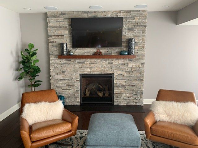 Echo ridge stack ledgestone fireplace with black granite hearth