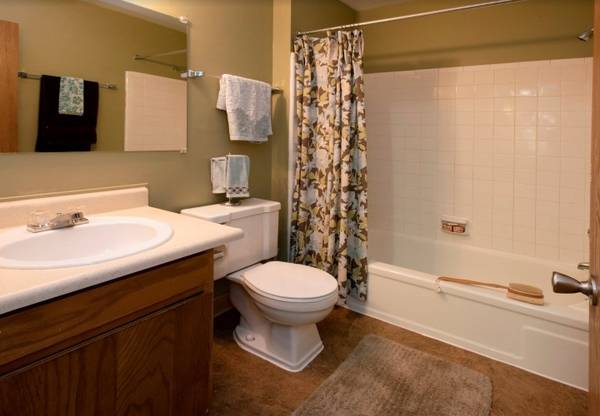 A bathroom with a toilet , sink and bathtub