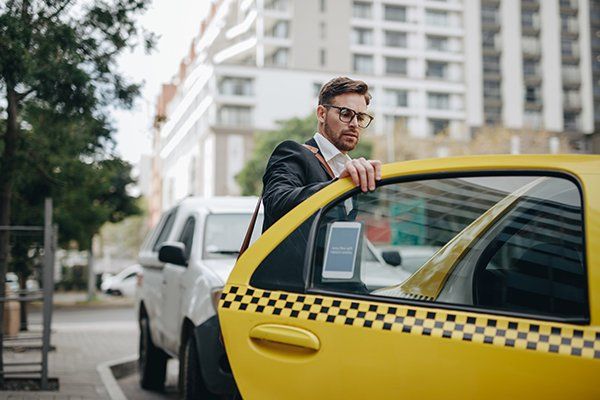 Man Taking a Taxi to Commute — Worcester, MA — Worcester Yellow Cab Man Taking a Taxi to Commute — Worcester, MA — Worcester Yellow Cab