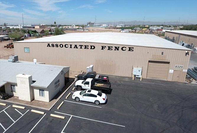 Associated Fence business building with vehicles in the parking lot.