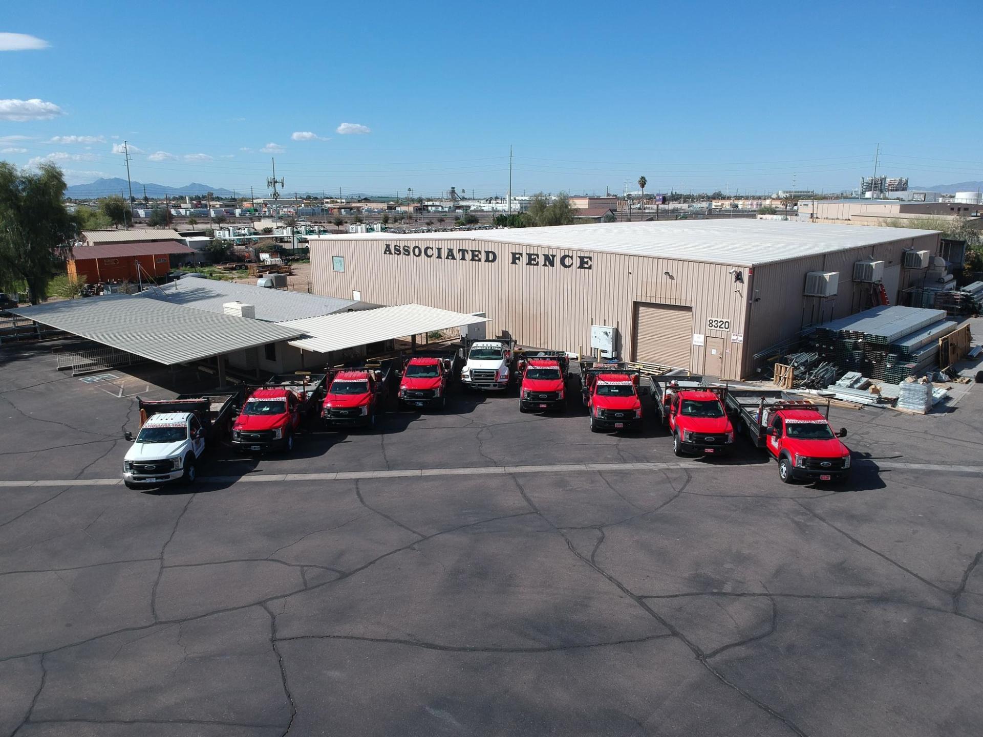 Associated Fence Exterior Photo with Work Trucks