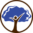 A person is standing in front of a tree with their arms outstretched.