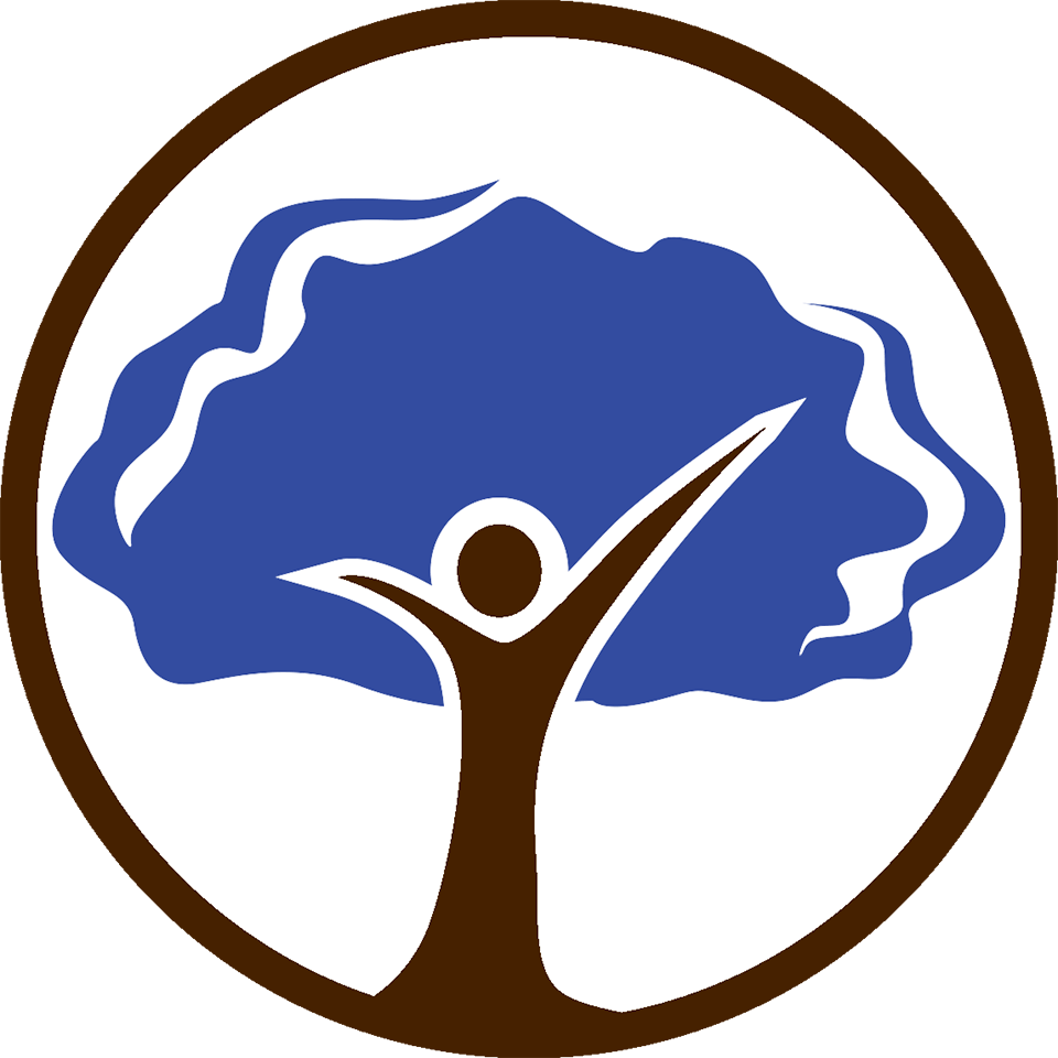 A person is standing in front of a tree with their arms outstretched.