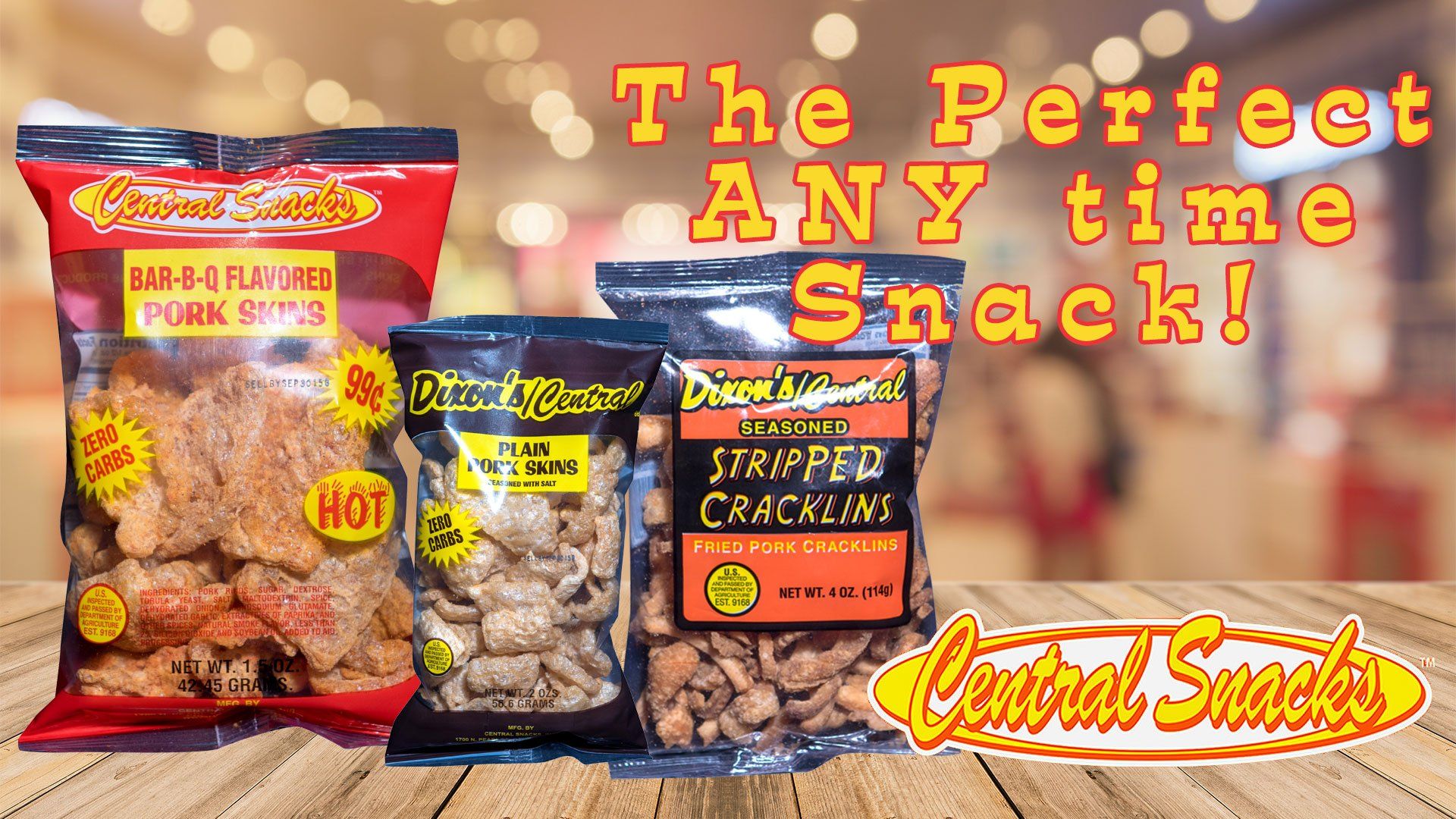 Three bags of snacks are sitting on a wooden table.