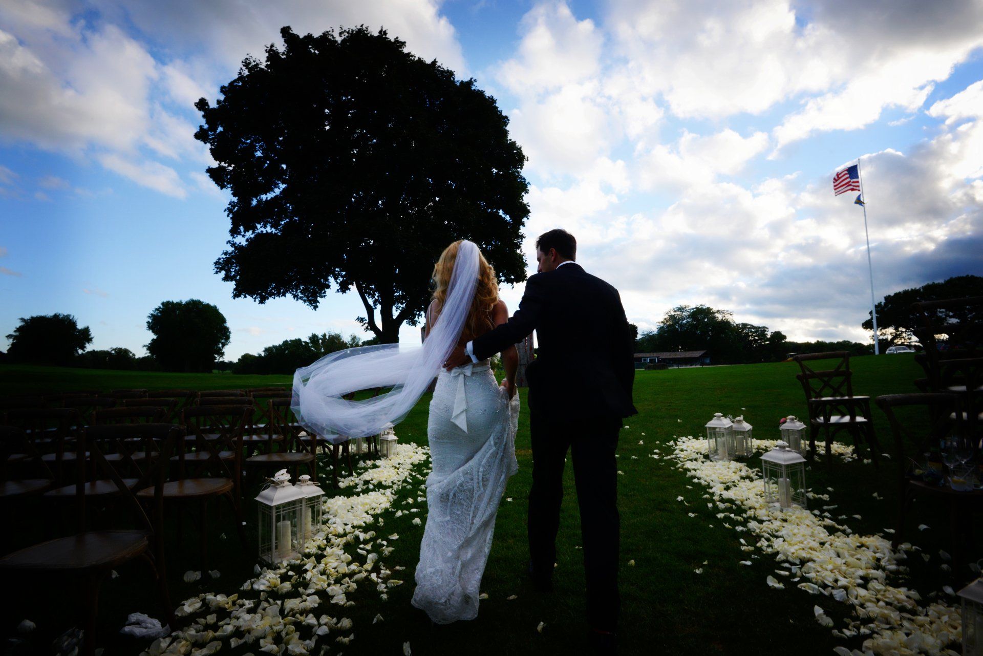 A bride and groom are walking down the aisle at their wedding