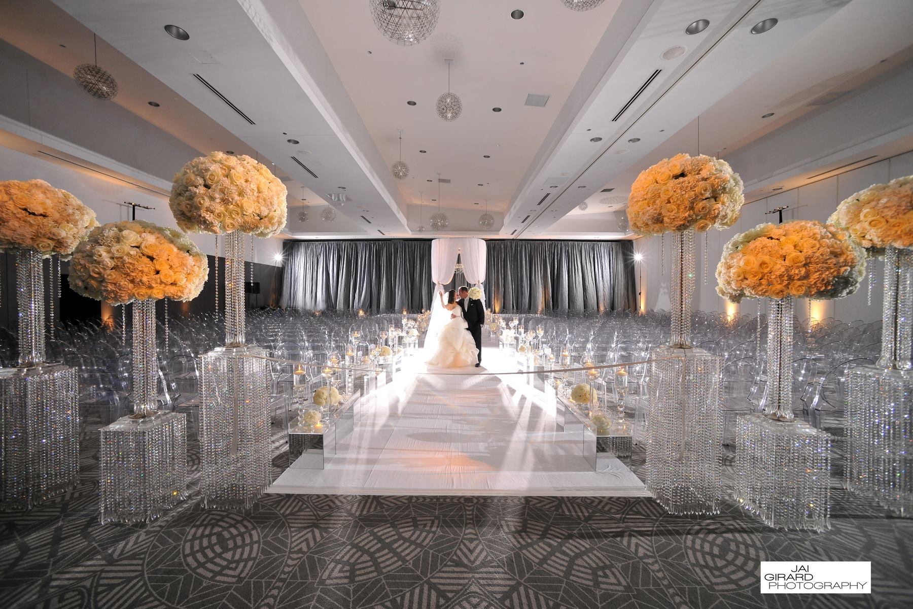 A bride and groom are walking down the aisle at a wedding ceremony