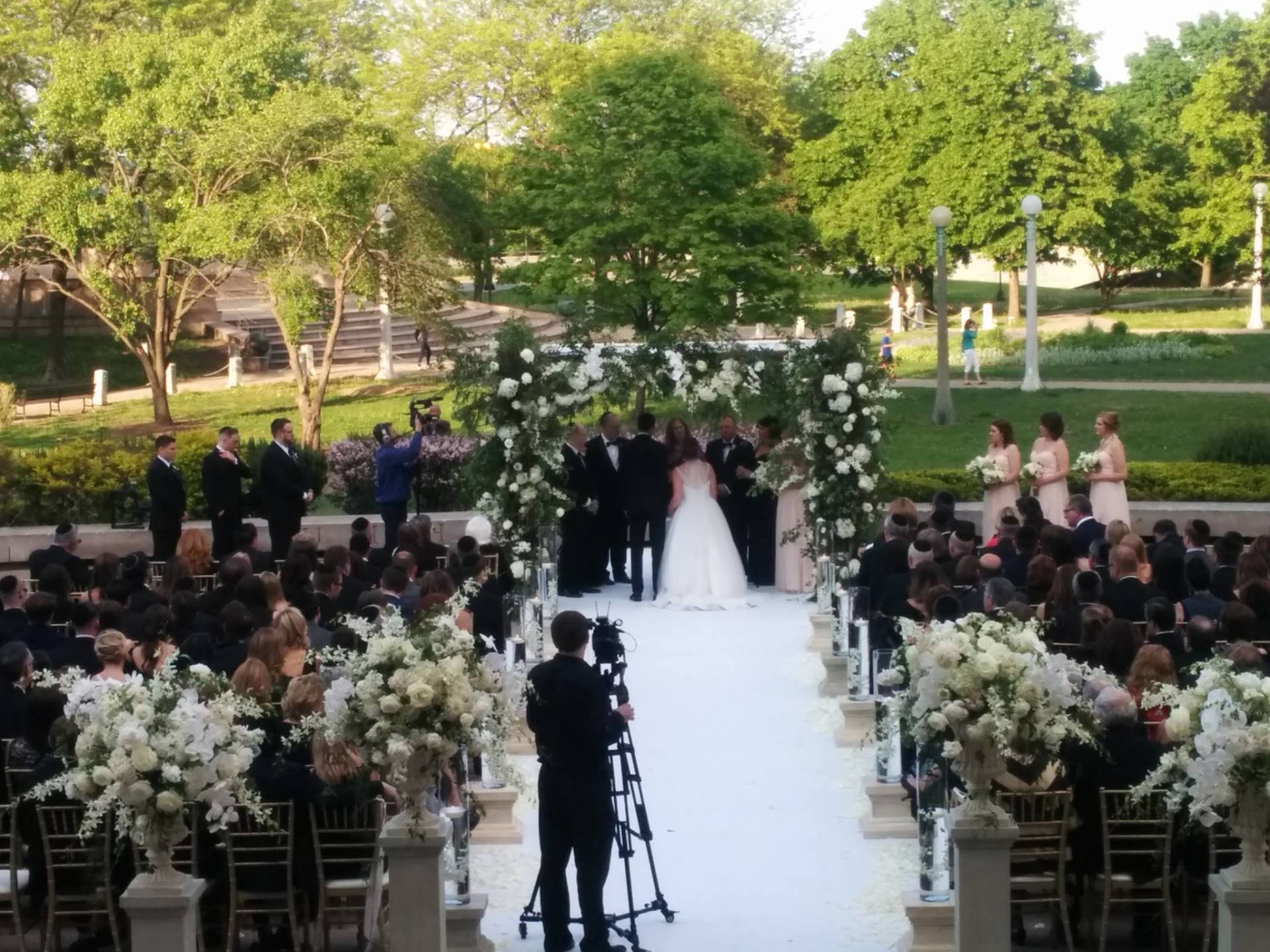 A bride and groom are walking down the aisle at a wedding ceremony