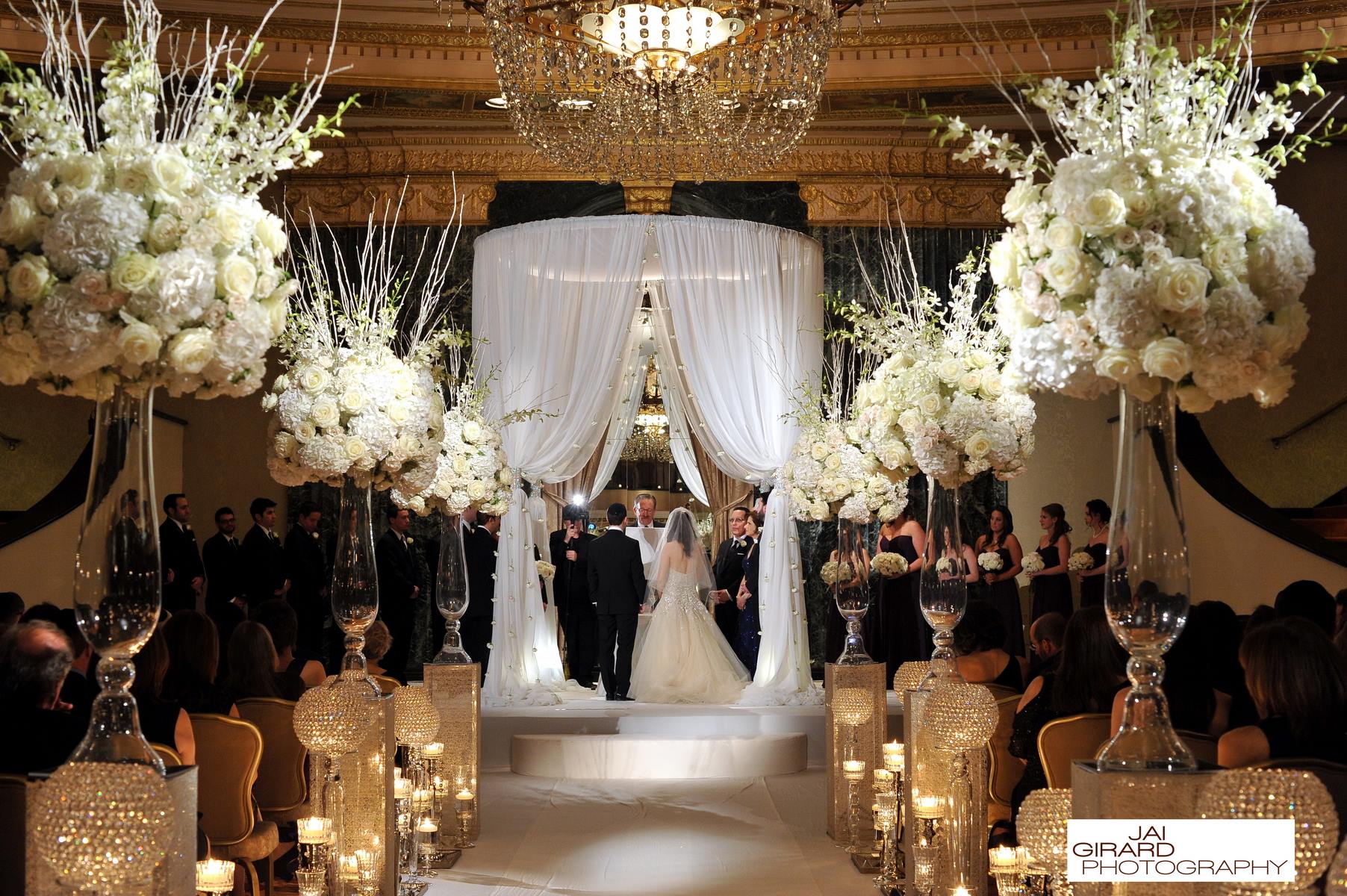 A bride and groom are walking down the aisle at their wedding ceremony