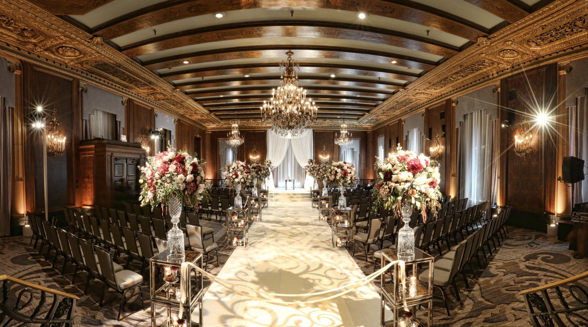 There is a long aisle in the middle of a large room.