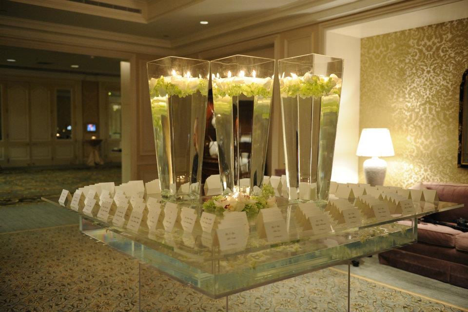 A table with candles and flowers on it in a room.