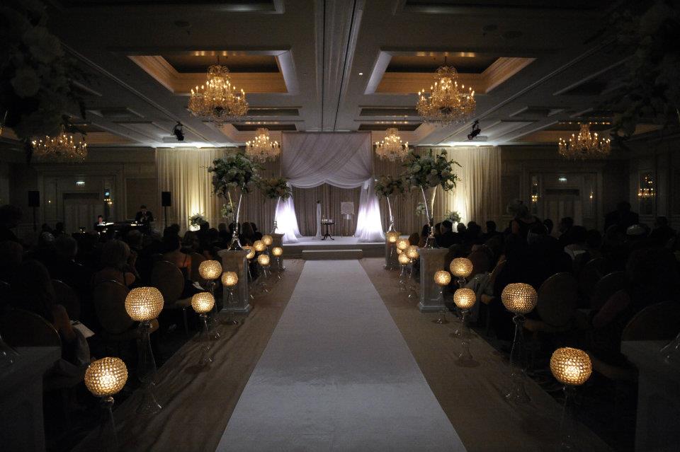 A wedding ceremony is taking place in a large room