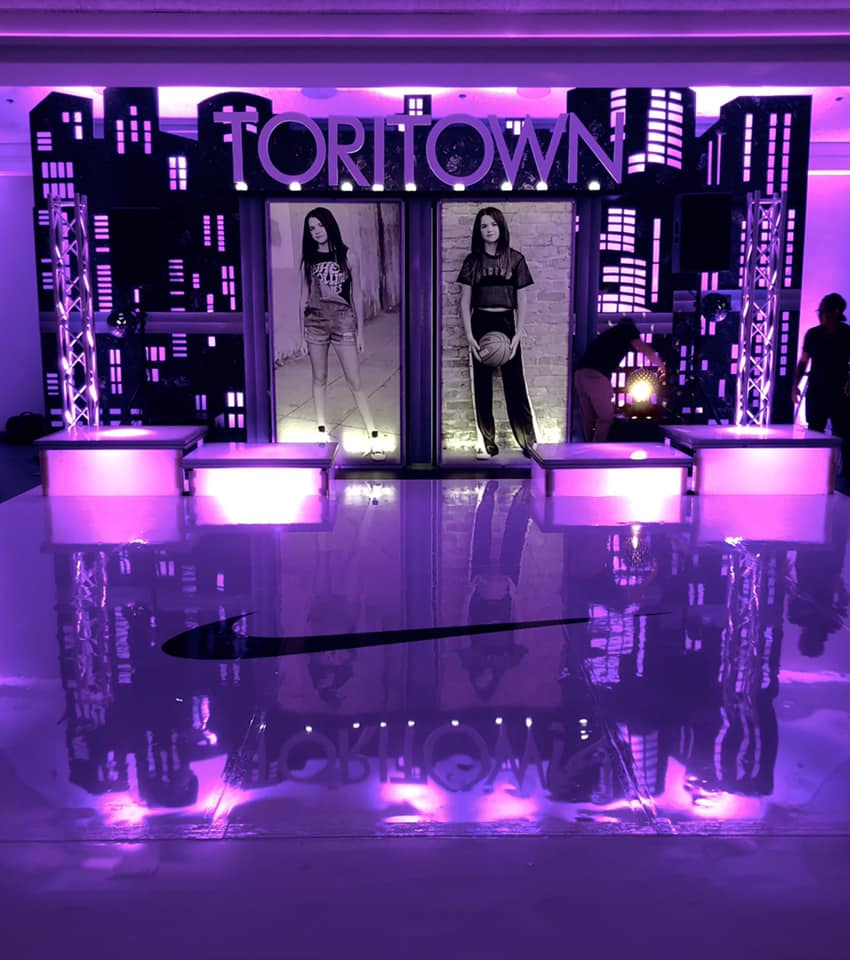 A room with purple lights and a sign that says tortown