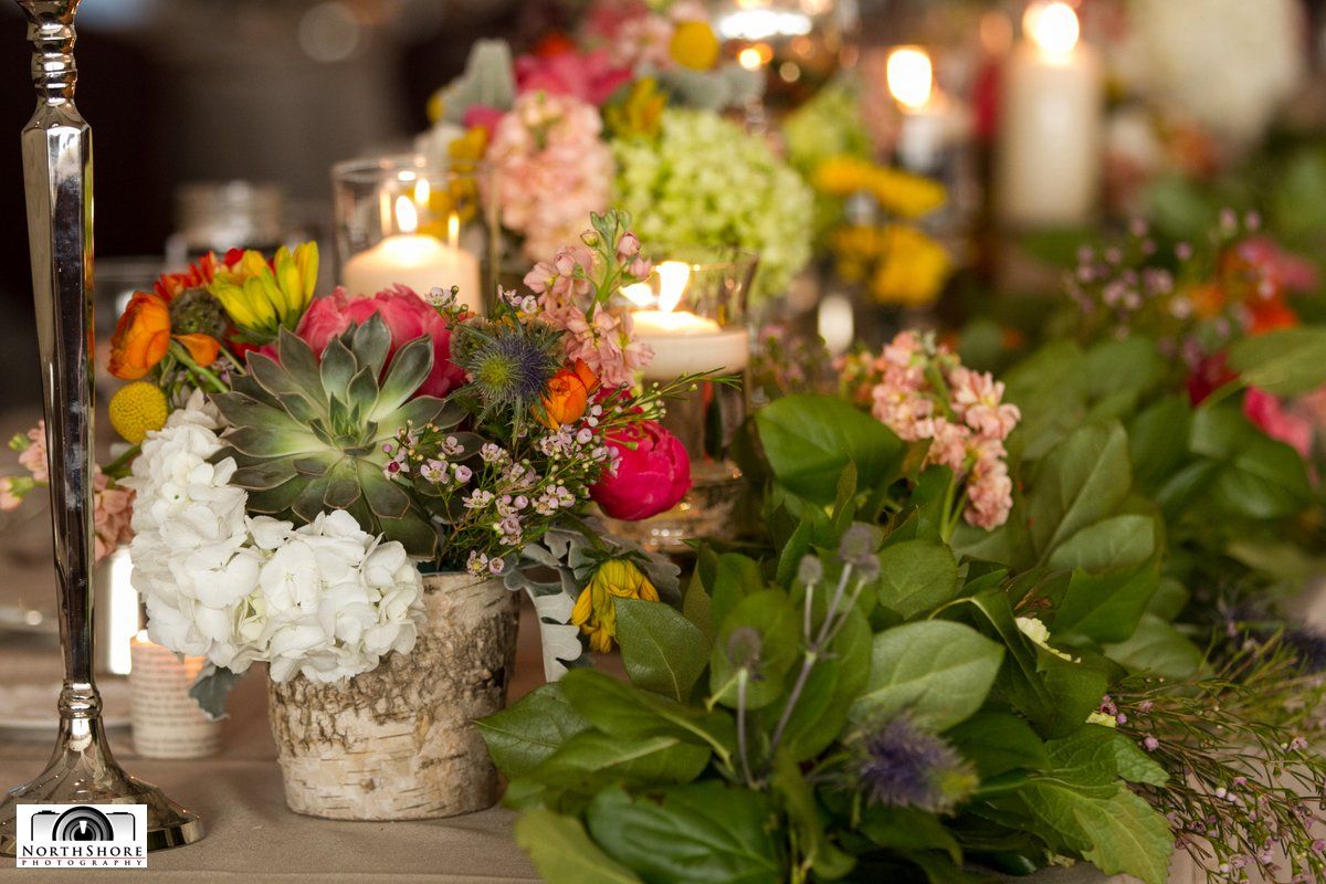 A table with flowers and candles on it