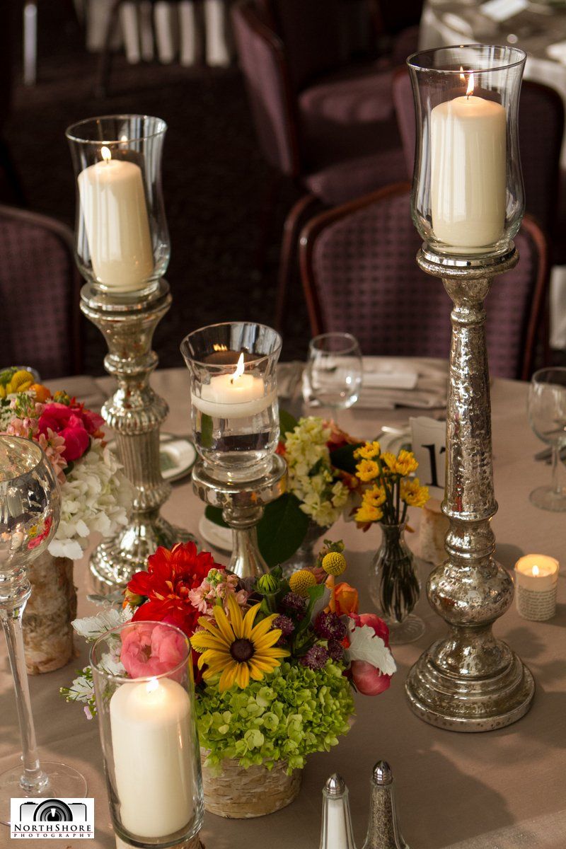 A table with candles and flowers on it