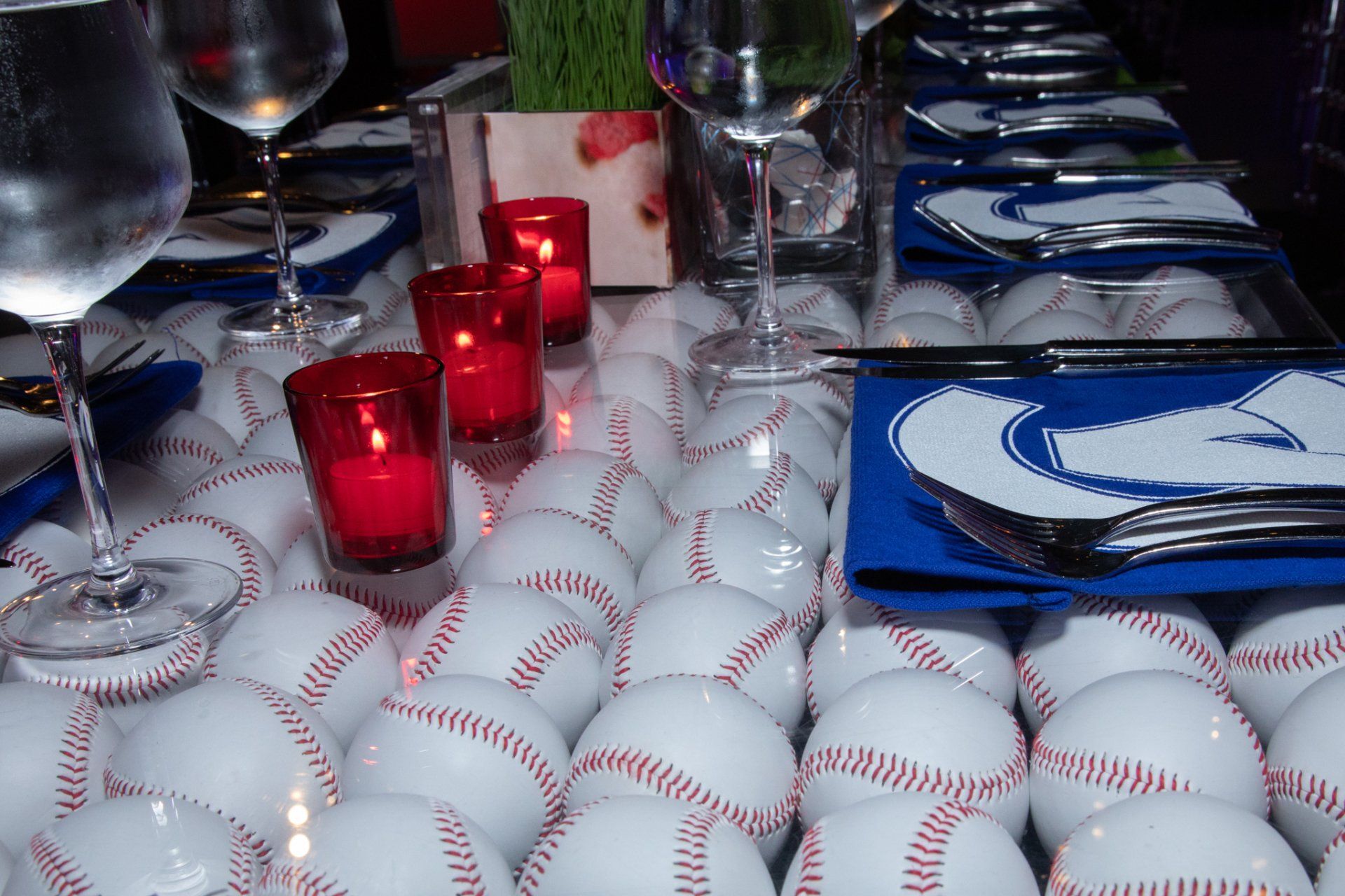 A table with a bunch of baseballs and candles on it