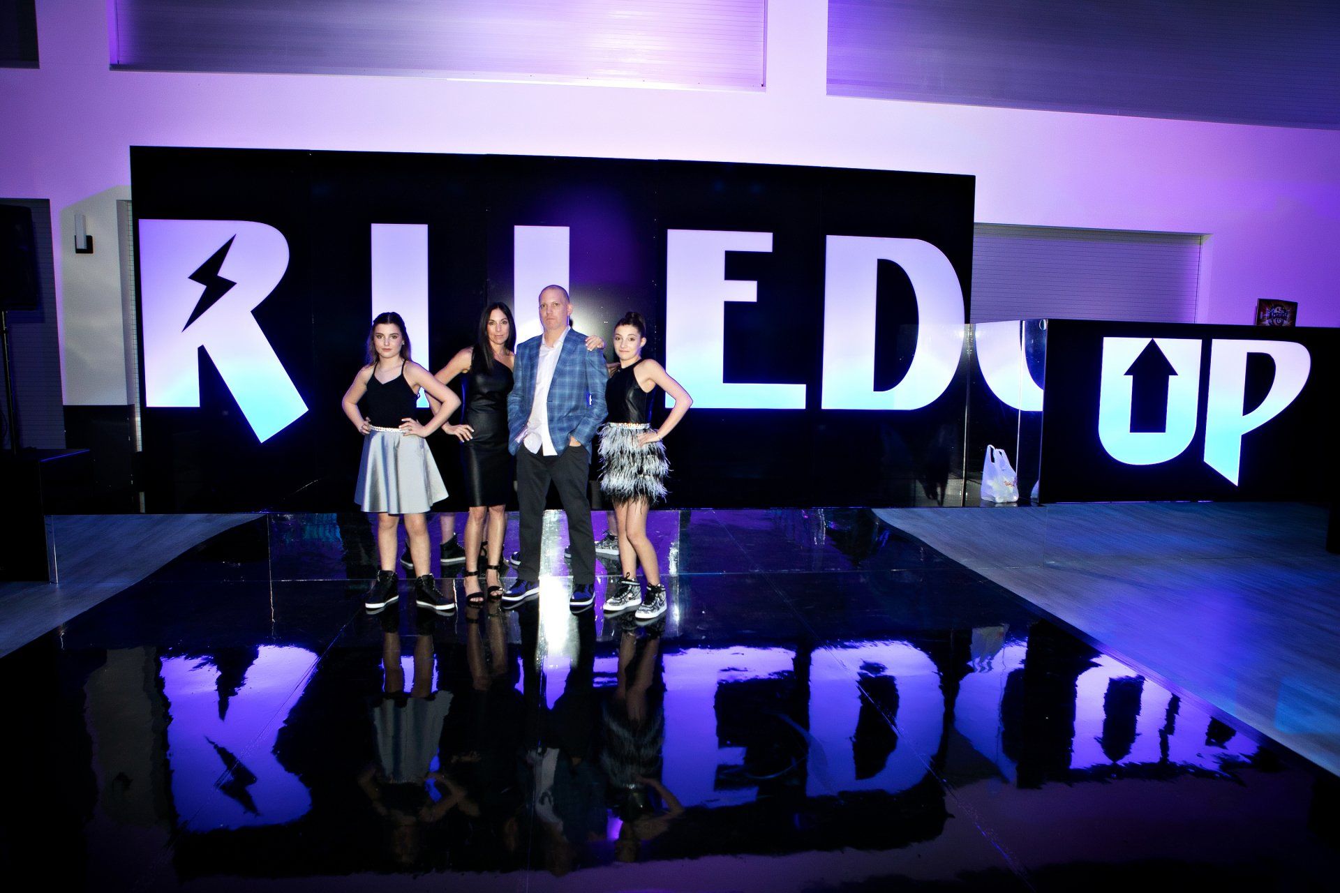 A group of people standing in front of a sign that says ruled up