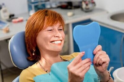 Patient looking at clean teeth - Dental Implants in Newport News, VA Patient looking at clean teeth - Dental Implants in Newport News, VA
