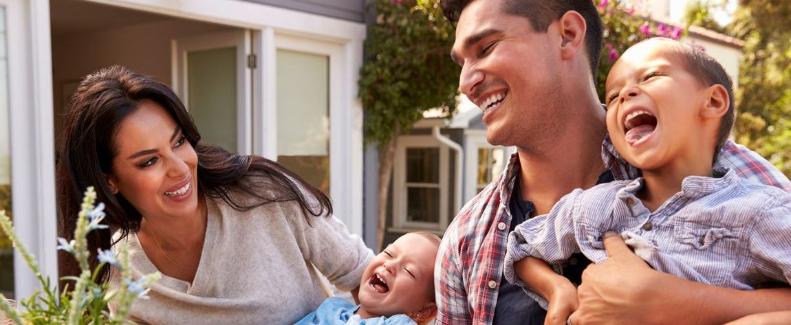 Family At Home Eating Outdoor Meal In Garden Together