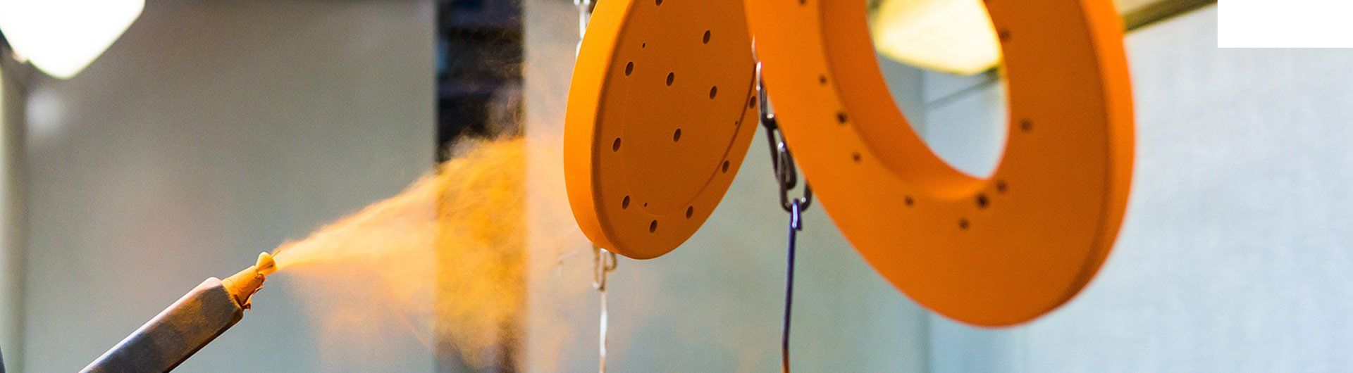spray gun spraying yellow paint