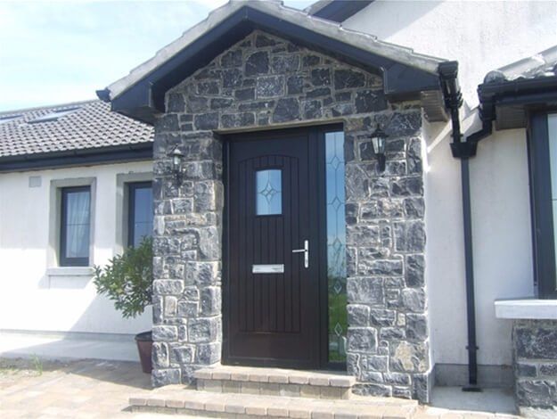 A white house with a black door and steps