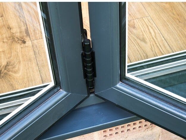 A close up of a sliding glass door on a wooden floor