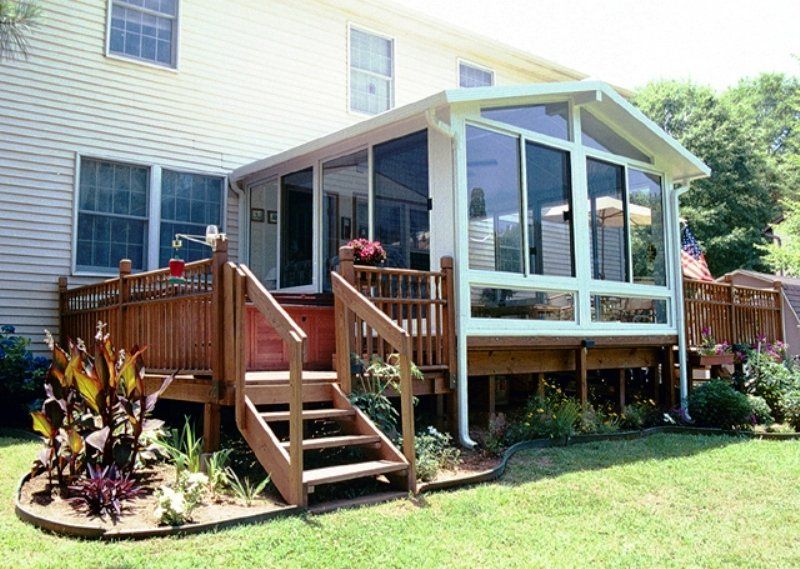 A house with a screened in porch and stairs