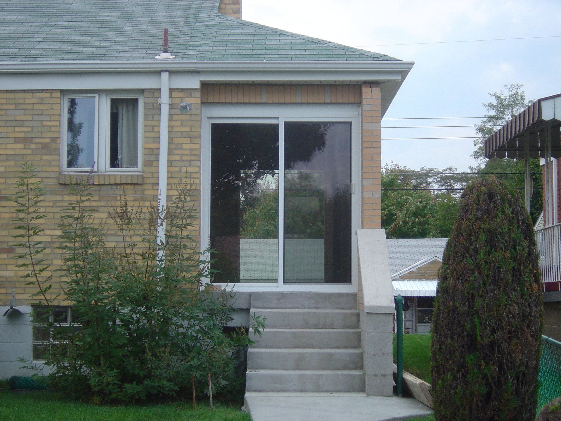 A brick house with a sliding glass door