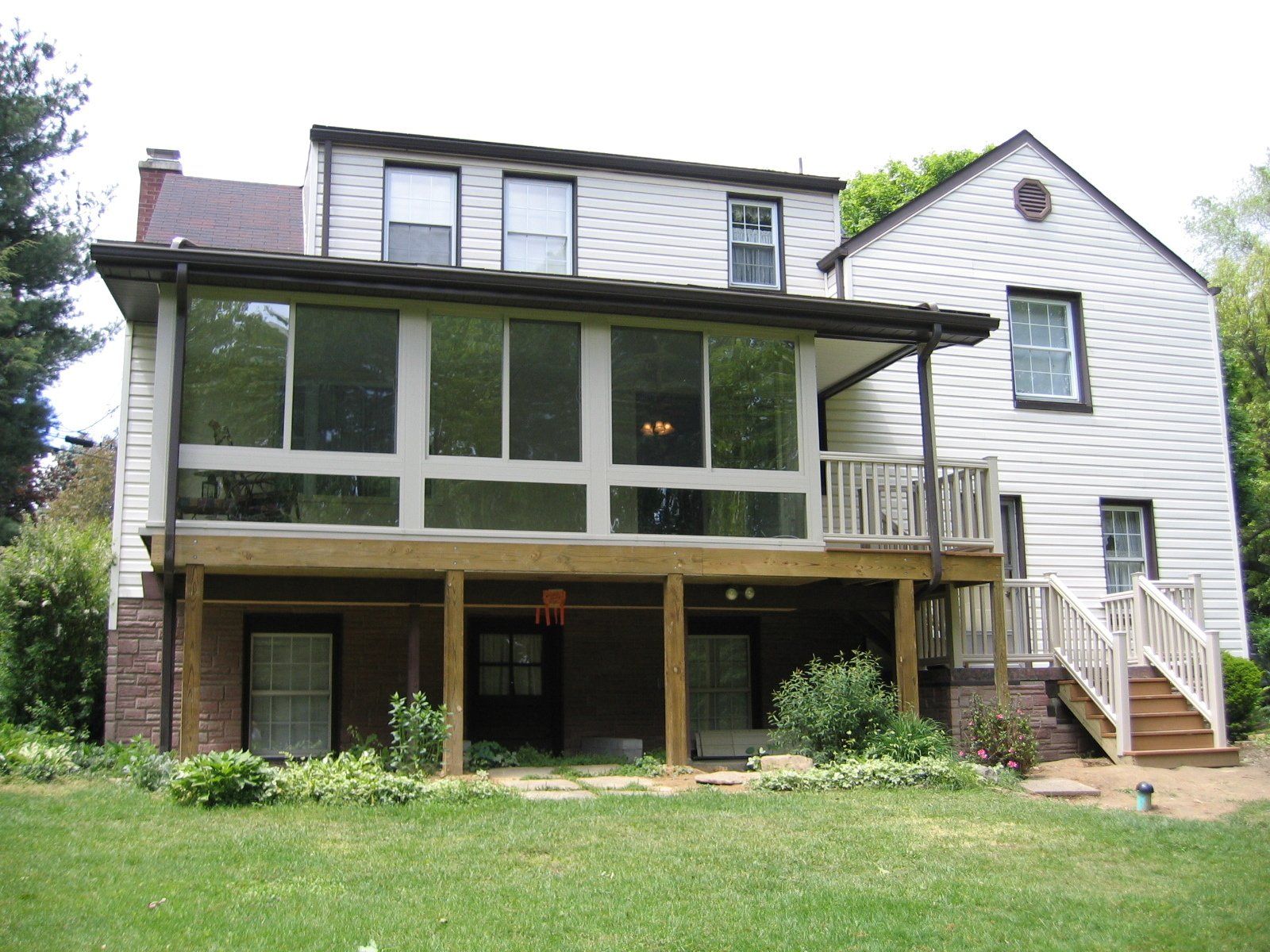 A white house with a large screened in porch