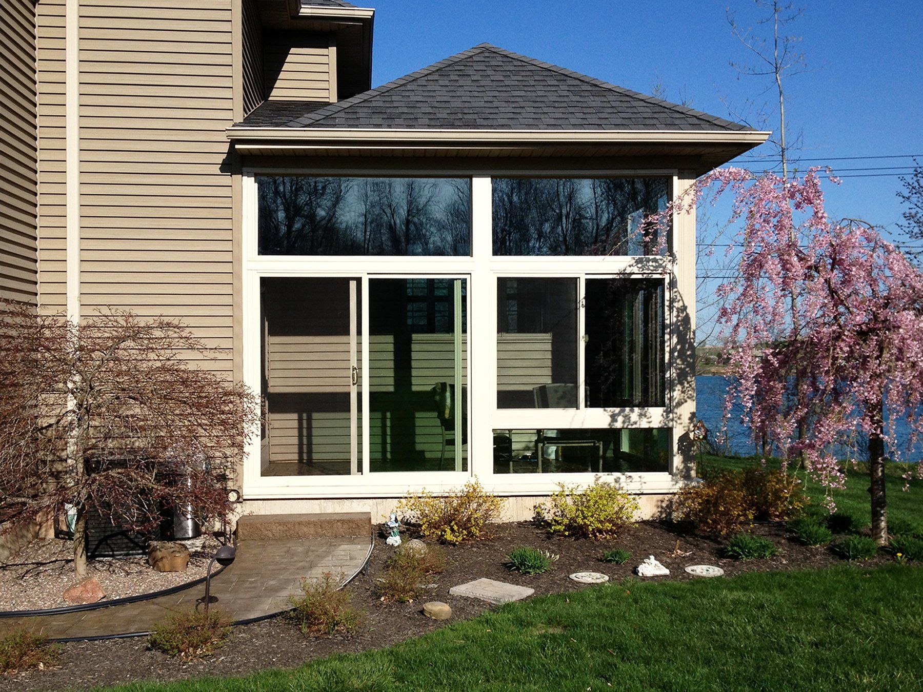A house with a lot of windows and a sliding glass door