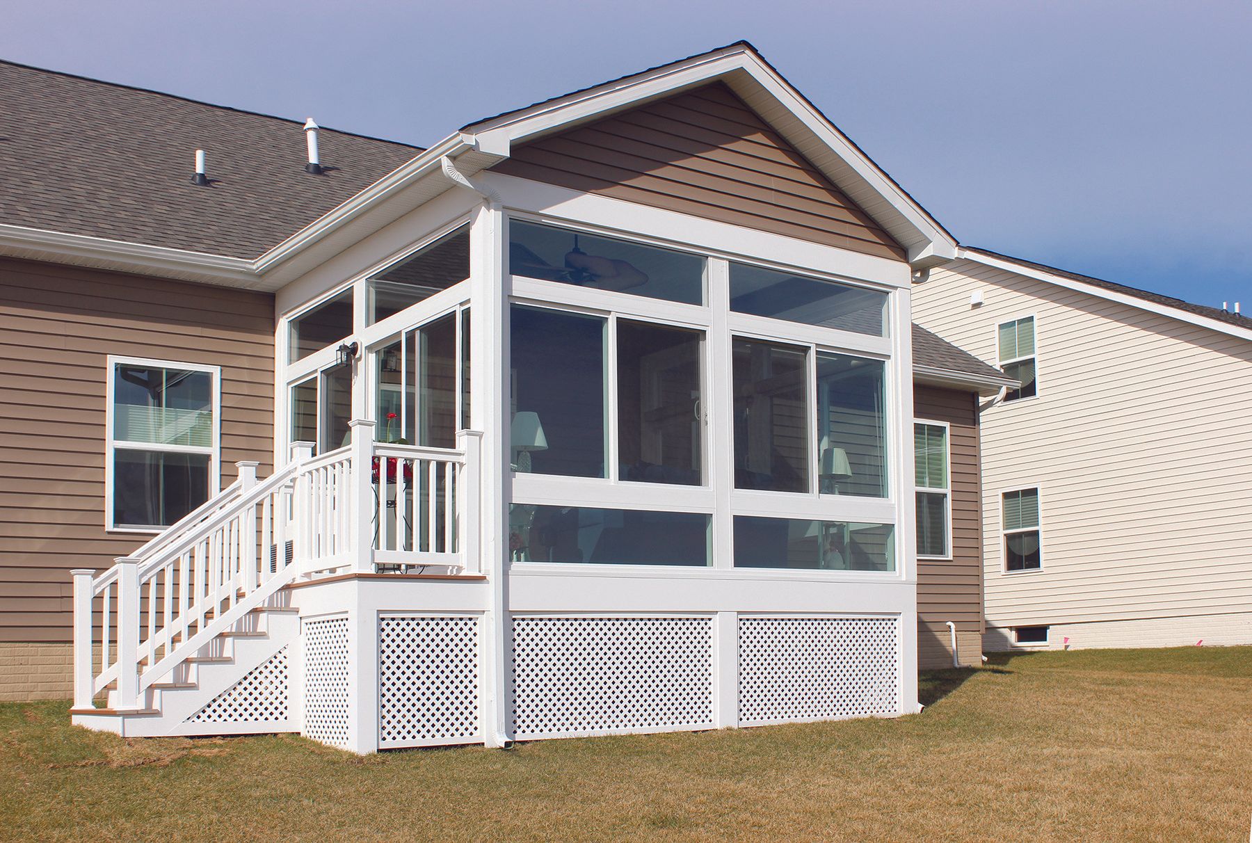 A house with a screened in porch and stairs