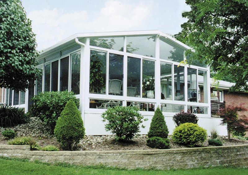 A house with a large sunroom with lots of windows