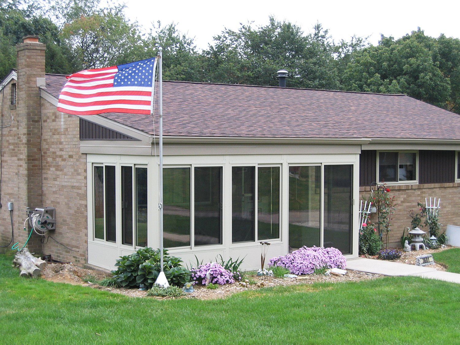 An american flag is flying in front of a house