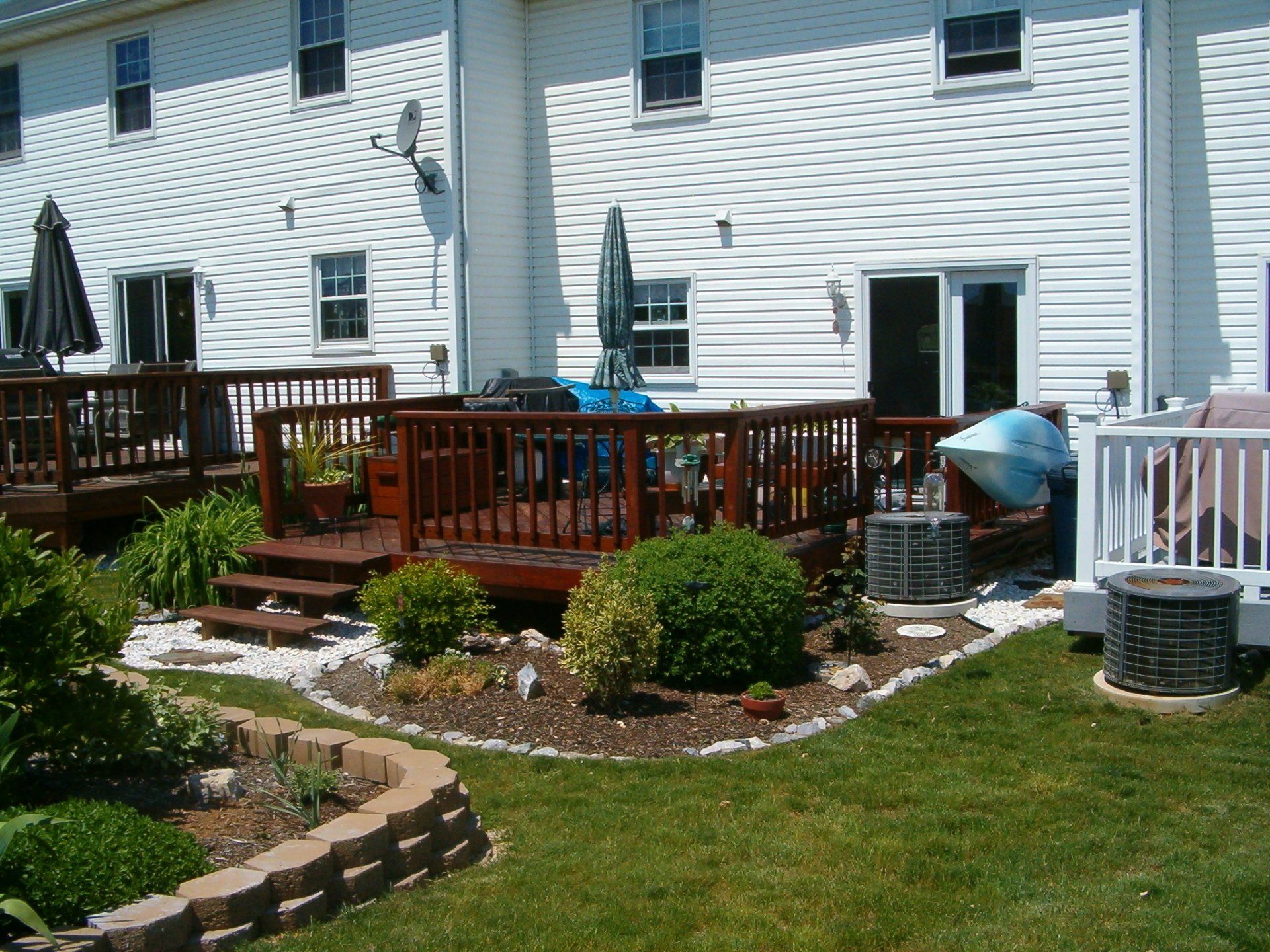 A white house with a wooden deck in front of it