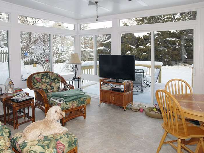 A dog is laying on a chair in a living room