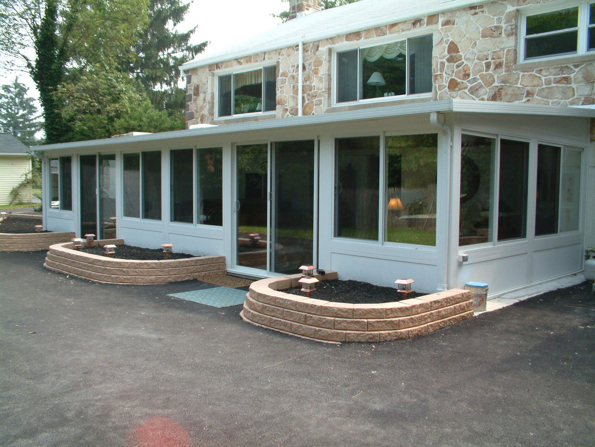 A large house with lots of windows and brick planters