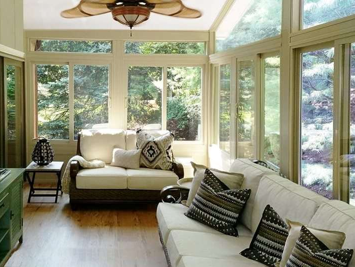 A living room with a couch and a ceiling fan