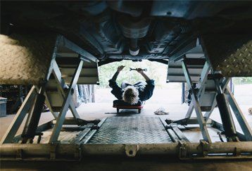 A mechanic working on a car near Narellan