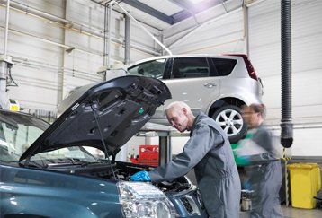 man working on a car ac system