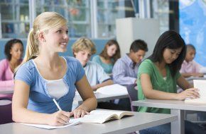 For a personal tutor in Manchester call 0161 441 6667 Students in a classroom sat at desks