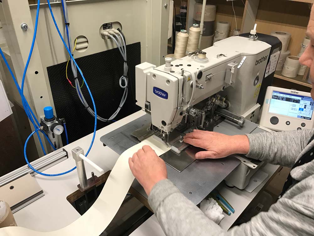 Repairs man sewing blinds